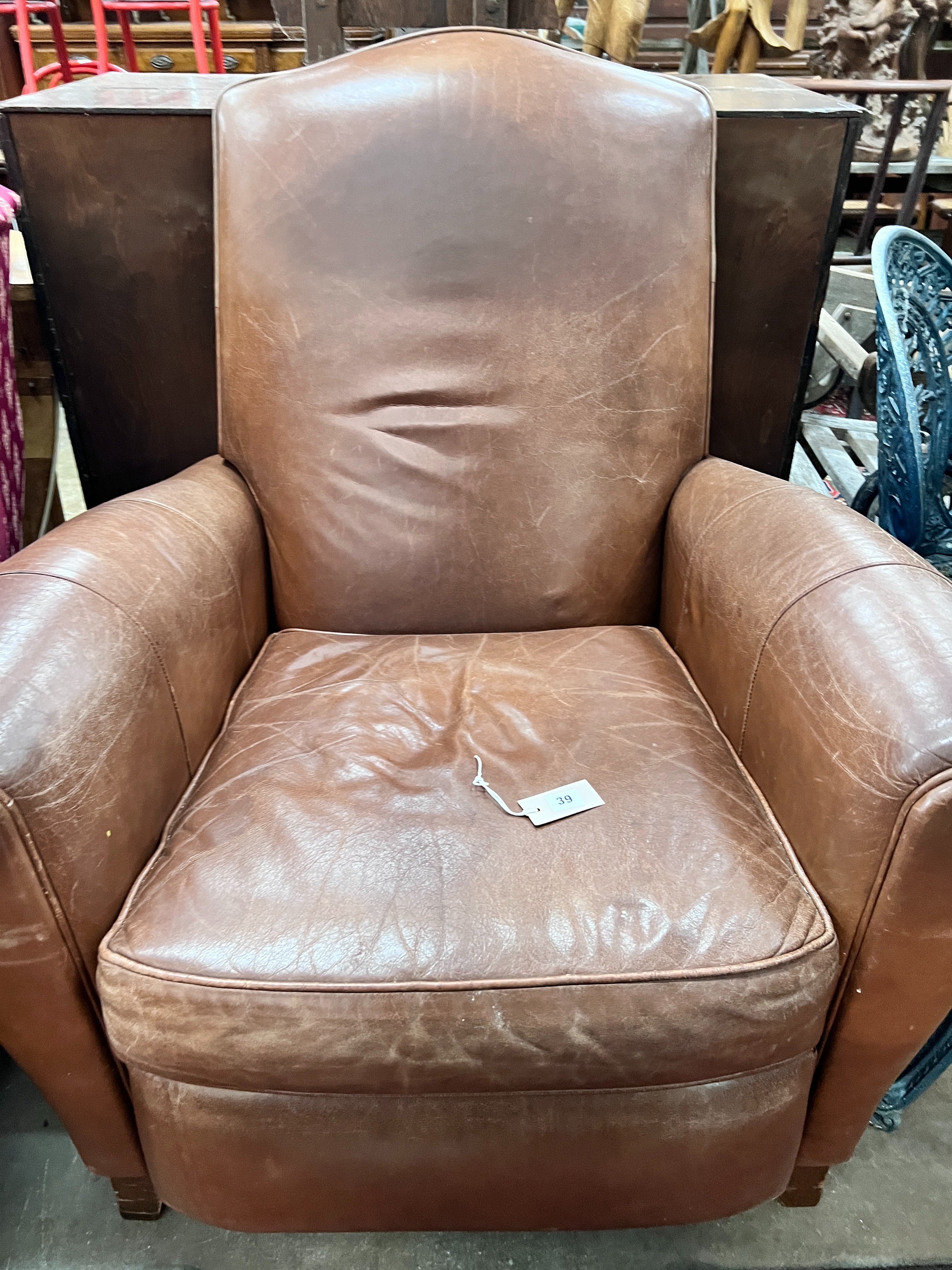 A contemporary tan leather reclining armchair with integral footrest, width 92cm, height 104cm *Please note the sale commences at 9am.